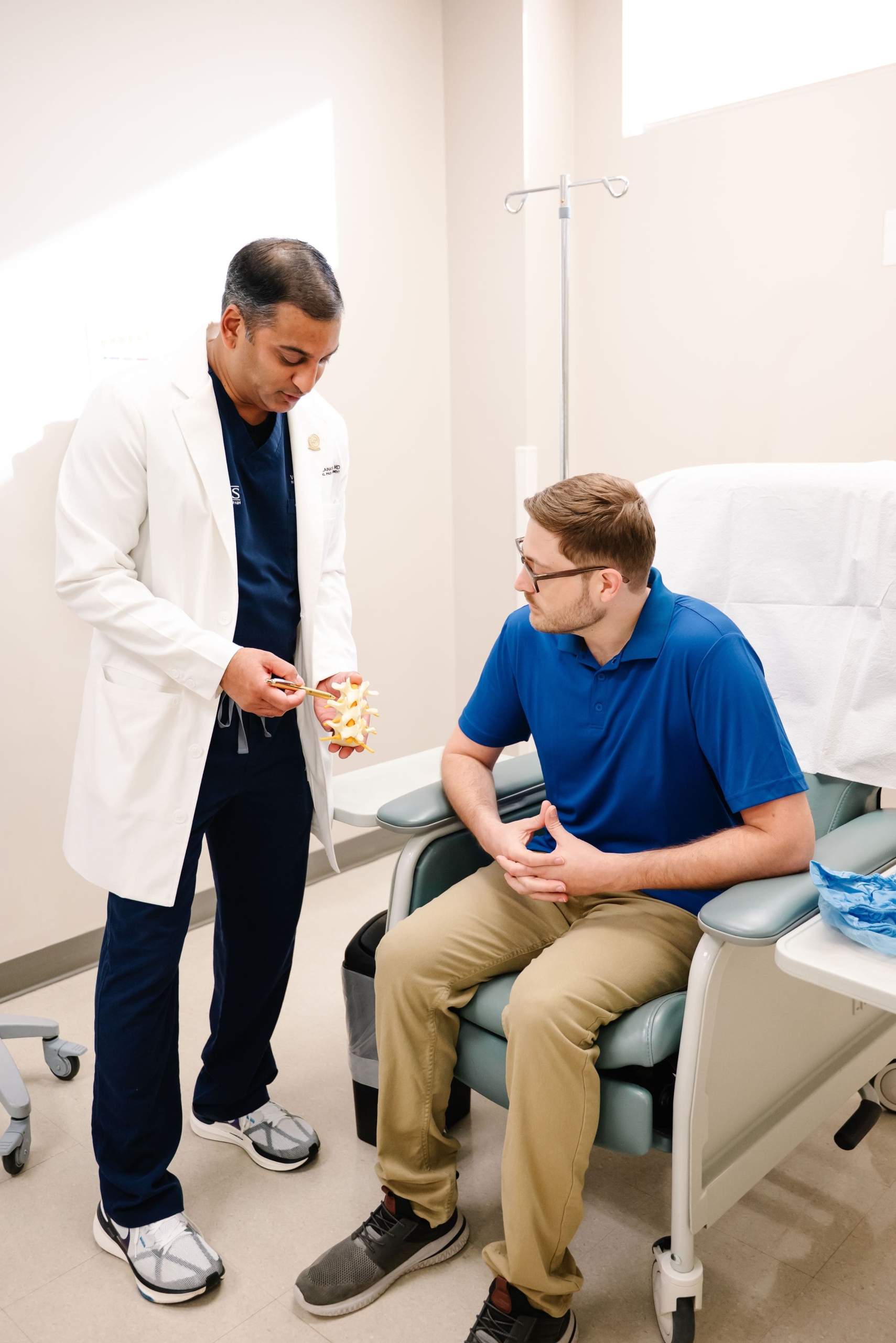 An image of a smiling patient and healthcare provider in a modern clinic setting, emphasizing personalized care and treatment.