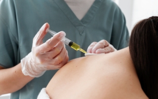 Medical professional administering injection therapy for neck pain relief to help patients stay active in Georgia